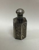 A Chinese silver scent bottle decorated in relief.