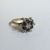 A 9 carat ruby and diamond daisy head cluster ring