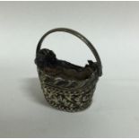 A miniature chased silver basket with swing handle