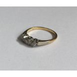 A diamond three stone ring in 18 carat gold and pl