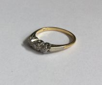 A diamond three stone ring in 18 carat gold and pl