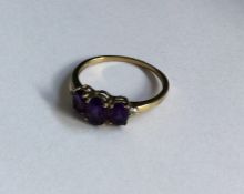 A tapering amethyst and diamond five stone ring in