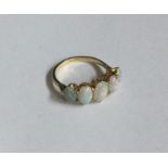 An 18 carat opal five stone tapering half hoop rin