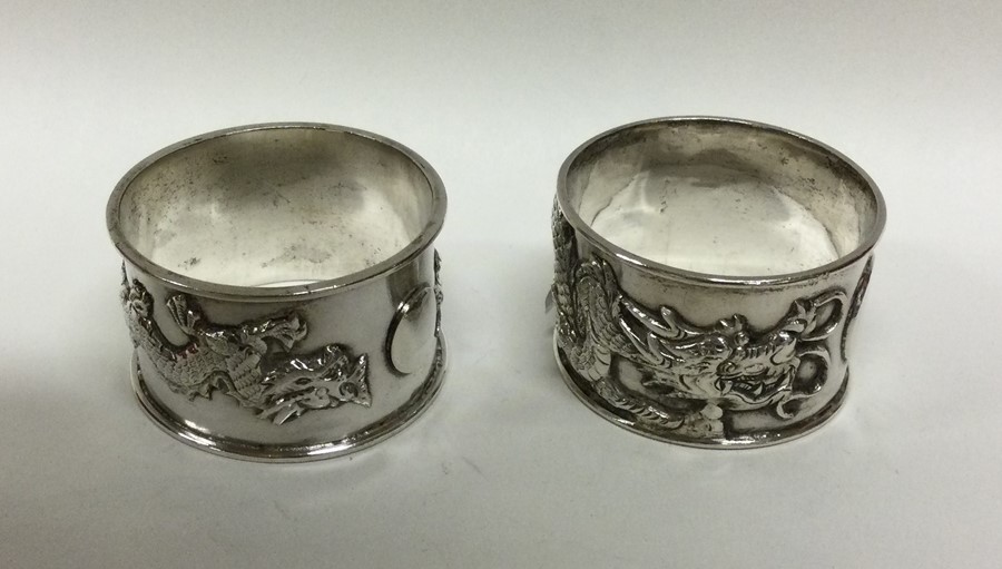 A good pair of chased silver napkin rings decorate