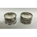 A good pair of chased silver napkin rings decorate