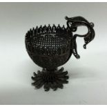 A Continental silver filigree egg cup with leaf de