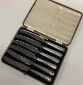 A boxed set of six silver handled tea knives. Est.