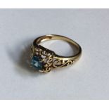 A small topaz single stone ring in scroll decorate