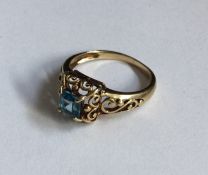 A small topaz single stone ring in scroll decorate