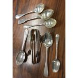 A group of silver teaspoons and tongs. Various dat