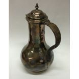 A George II baluster shaped silver jug with cane h