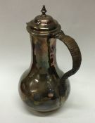 A George II baluster shaped silver jug with cane h