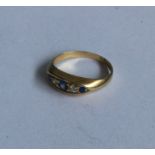 A diamond and sapphire five stone boat shaped ring