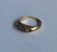 A diamond and sapphire five stone boat shaped ring