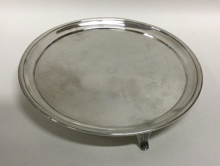 A Georgian silver salver of circular form on sprea