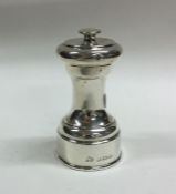 A circular silver pepper grinder. Birmingham. By E