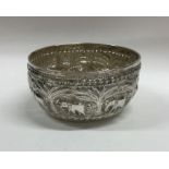 An Indian silver bowl chased with scrolls and flow