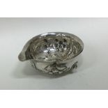 A small silver bowl / jug decorated with flowers.