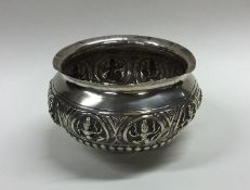 An Indian silver sugar bowl of half fluted design