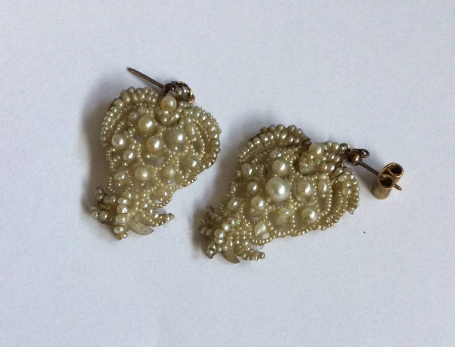 A pair of gold mounted seed pearl drop earrings. A