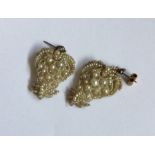 A pair of gold mounted seed pearl drop earrings. A