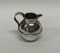 A miniature silver jug in the form of a Jersey Can