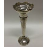 A tapering Edwardian silver spill vase with shaped