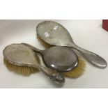 A group of three silver mounted hairbrushes. Est.