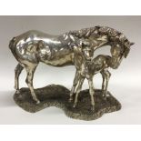 A large silver mounted model of a horse with foal.