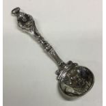 A heavy large crested silver caddy spoon with loop