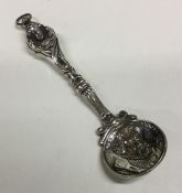 A heavy large crested silver caddy spoon with loop