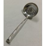 A heavy silver sifter spoon with engraved bowl. Bi