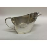 An engine turned silver sauce boat with reeded bor