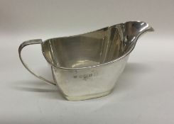 An engine turned silver sauce boat with reeded bor