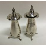 A pair of Edwardian silver peppers of typical form