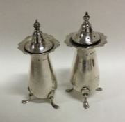 A pair of Edwardian silver peppers of typical form