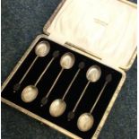 A cased set of six silver bean top coffee spoons.