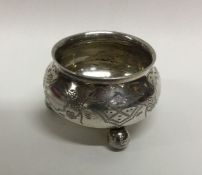 A circular Russian silver salt on ball feet. Appro