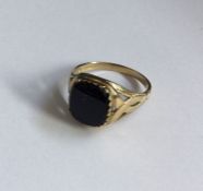 An onyx and diamond gent's signet ring in claw mou