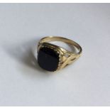 An onyx and diamond gent's signet ring in claw mou