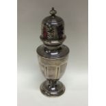 An Edwardian silver sugar caster of shaped form. A