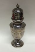 An Edwardian silver sugar caster of shaped form. A