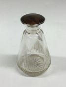 A glass mounted and tortoiseshell scent bottle wit