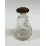 A glass mounted and tortoiseshell scent bottle wit