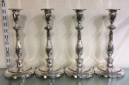 A good rare set of four Georgian silver candlestic