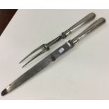 A Georgian two piece silver carving set of taperin