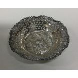 A circular Edwardian silver bonbon dish decorated