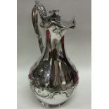 A fine quality Victorian chased silver jug embosse