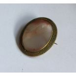 An Antique banded agate brooch in gold reeded fram