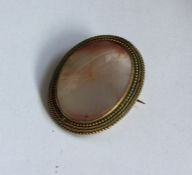 An Antique banded agate brooch in gold reeded fram